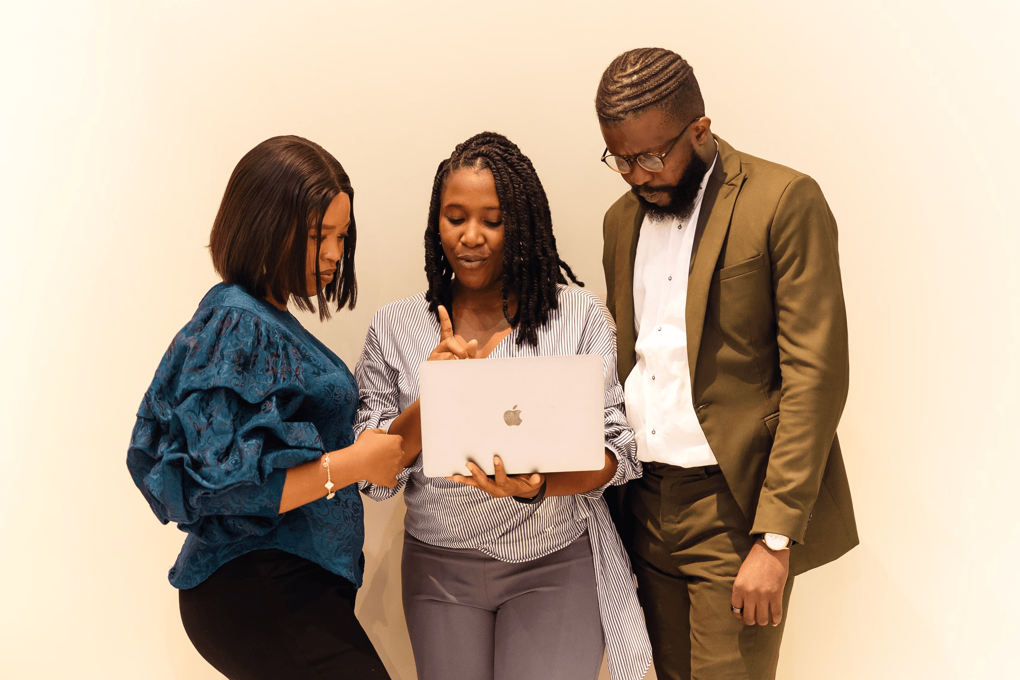 A collaborative team working around a laptop